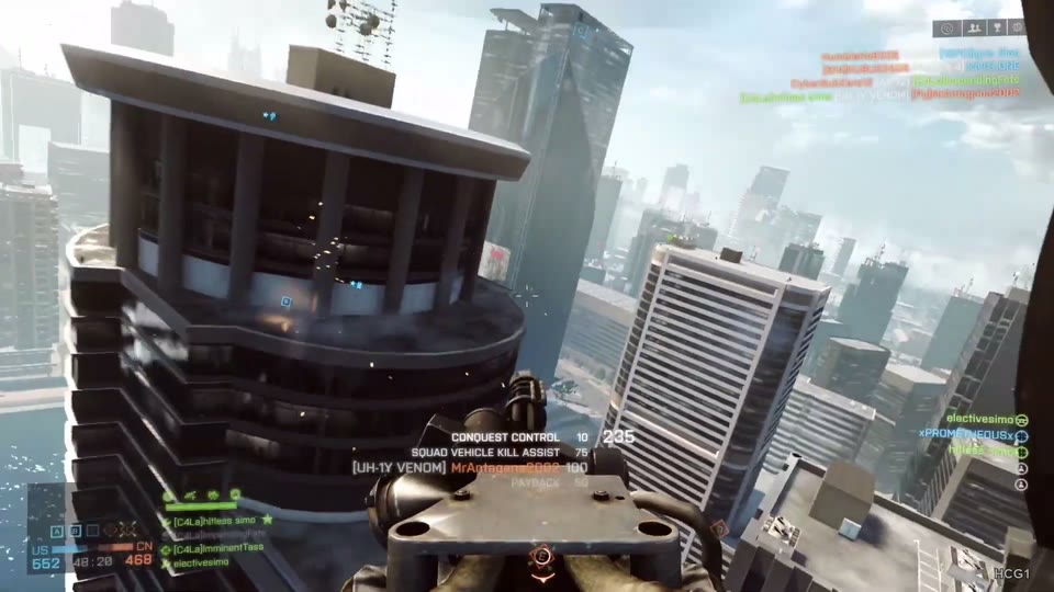 Helicopter door-gunner viewpoint beside a high-rise roof, with tilted city skyline and distant harbor.
