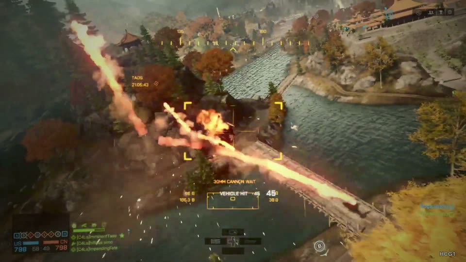 Aircraft-view fire trails over a bridge with water, autumn trees and pagoda architecture.