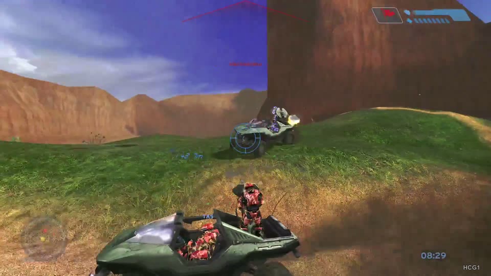 Red-armored Warthog crew in the foreground; a second Warthog firing on the slope.